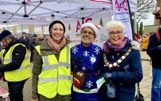 Jane Barnes, the chair of volunteer-run Amersham Action Group (L) with BJ Tailor from Tesco (C) and Mayor Cllr Elizabeth Shepherd (R) taken outside AAG's stall at the Christmas Festival last year