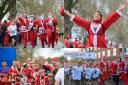 PICTURES: Thousands of Santas stream through town for annual fun run