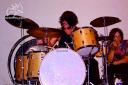 Joe the Jammer crouches next to Led Zeppelin drummer John Bonham