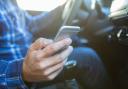 Stock image on man on phone while driving