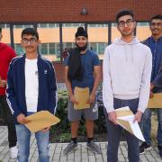 Students at Khalsa Secondary Academy in Stoke Poges celebrating getting their results
