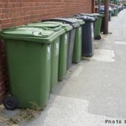 Recycling bins blocking a pavement.