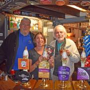 Local CAMRA members Eddie Harman and Tony Gabriel with Wheel licensee Claire Christian