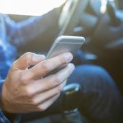 Stock image on man on phone while driving