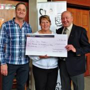 Peter Keenan (Trustee, left) and Sarah Mordaunt (Director) accept a cheque from Bill Reid of the Buckinghamshire Community Foundation.