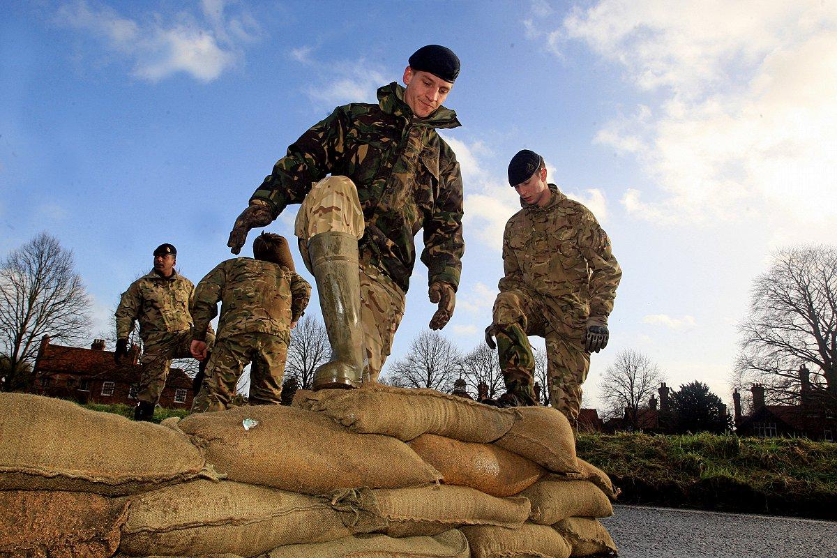 Troops descend on Cookham to lay sandbags to protect the village from more flooding.