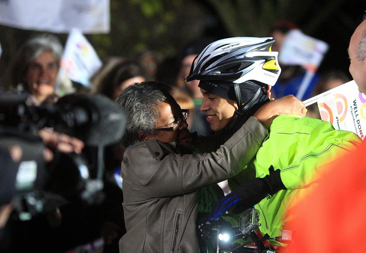 Heartfelt embraces greet Alex's achievement.