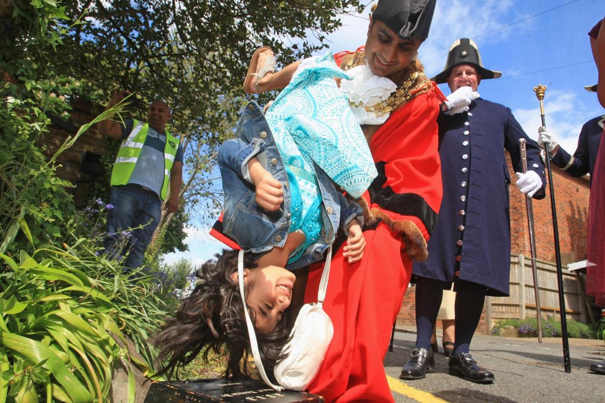 Children were in for a shock at the weekend as they were turned upside down and lowered onto a stone – as people in the town celebrated one of Wycombe’s longest-standing traditions.