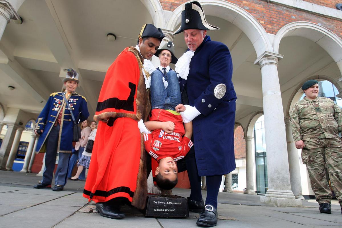 Children were in for a shock at the weekend as they were turned upside down and lowered onto a stone – as people in the town celebrated one of Wycombe’s longest-standing traditions.