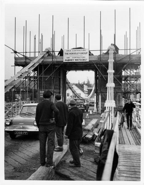 View from The Causeway of repairs to the bridge, but with motor vehicles still passing over, Marlow. February 1965.