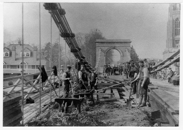 Looking North, a view of workmen repairing the carriageway on Marlow Bridge, Marlow. c 1890's.