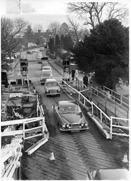 Looking N, an elevated view of traffic approaching the bridge during refurbishment. The Causeway, Marlow. 1965.