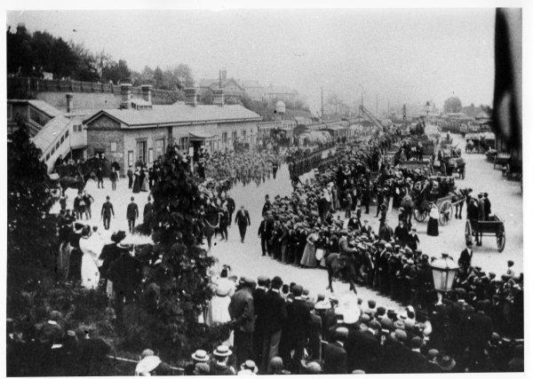 Crowd greeting a trainload of Militia returning from the Boer War. Outside the railway station, High Wycombe. c1901
