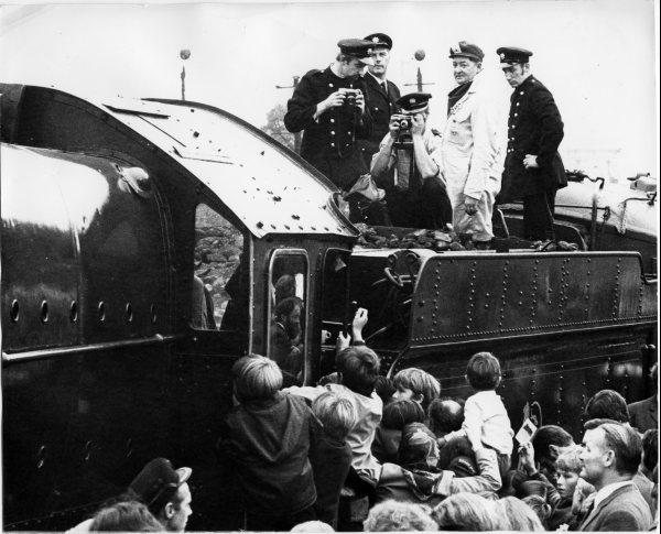 Close-up view of crowds around the cab of the railway locomotive King George V near the up-platform of the railway station, High Wycombe. October 1971.