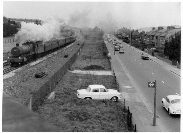 Looking east, a view of mainly the southern side of the road, with a steam train proceeding west along adjacent track. West Wycombe Road, High Wycombe, April 1962