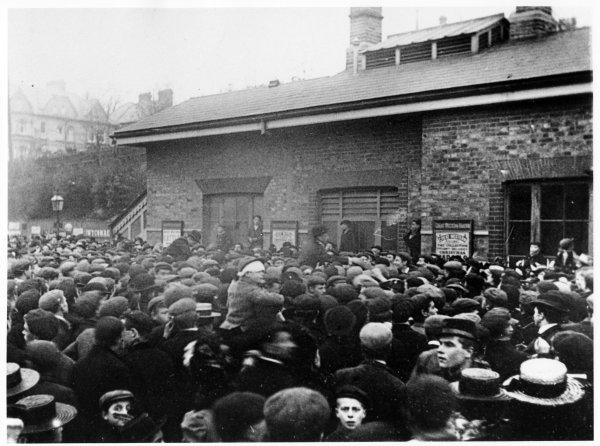 Crowd waiting to greet a trainload of Militia returning from the Boer War. Outside the railway station, High Wycombe, circa 1901.
