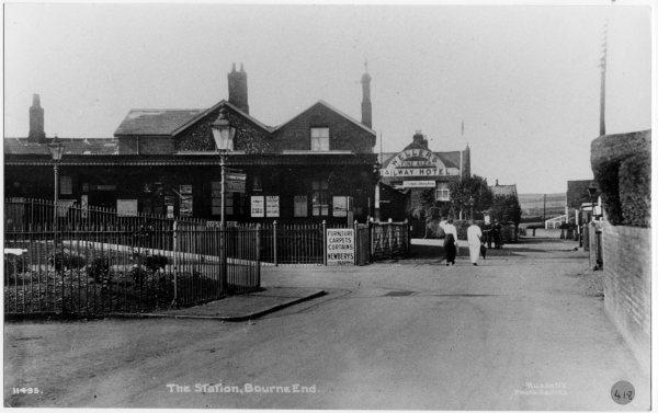 Looking north, a view of the railway station and level crossing, the Railway Hotel behind, and the countryside beyond. Station Rd, Bourne End, c 1916