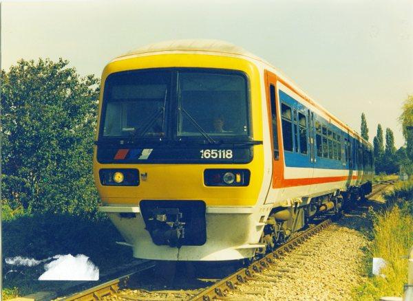 Looking east, a view of a diesel locomotive No.165118, the Marlow Donkey, on the Marlow - Bourne End line near Bourne End. 1990s