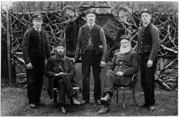 View of the railway station staff, 5 men, two of whom are seated, and three standing, Bourne End, Wooburn. 1892.