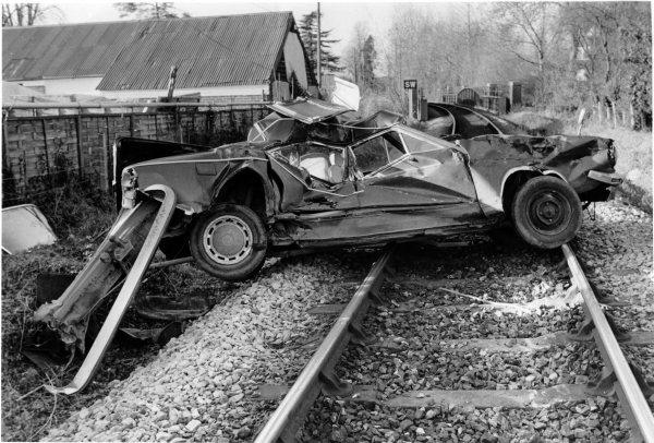 Looking west, a view of a badly damaged car across the railway line after it had been struck by a train, near Donkey Lane, Bourne End. Dec 1986