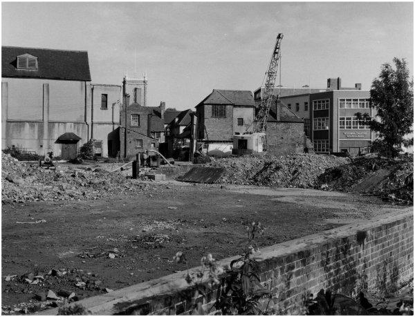 A view looking south east across Newland Street showing construction work at the western end of White Hart Street, High Wycombe. September 1965