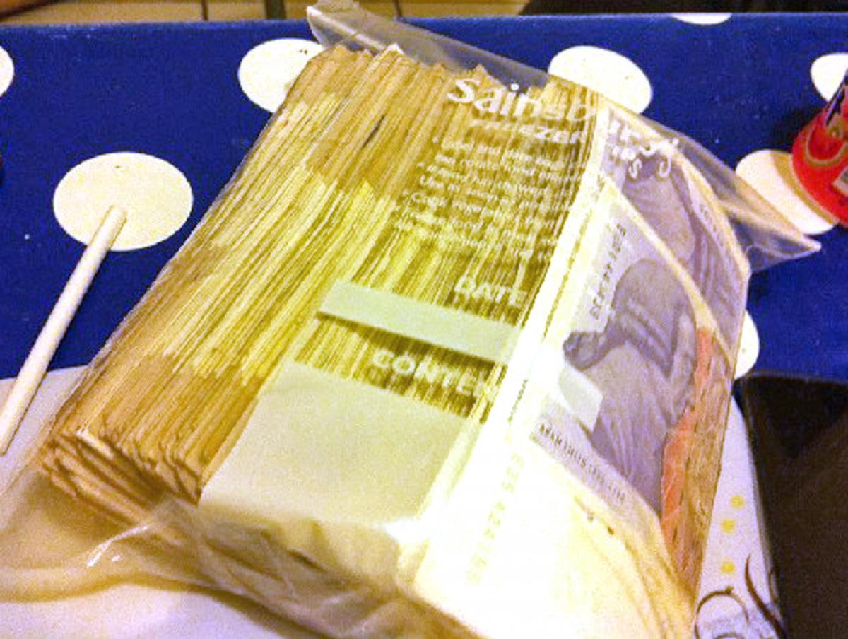Cash in a bag found at a flat in Manchester. National Crime Agency/PA Wire