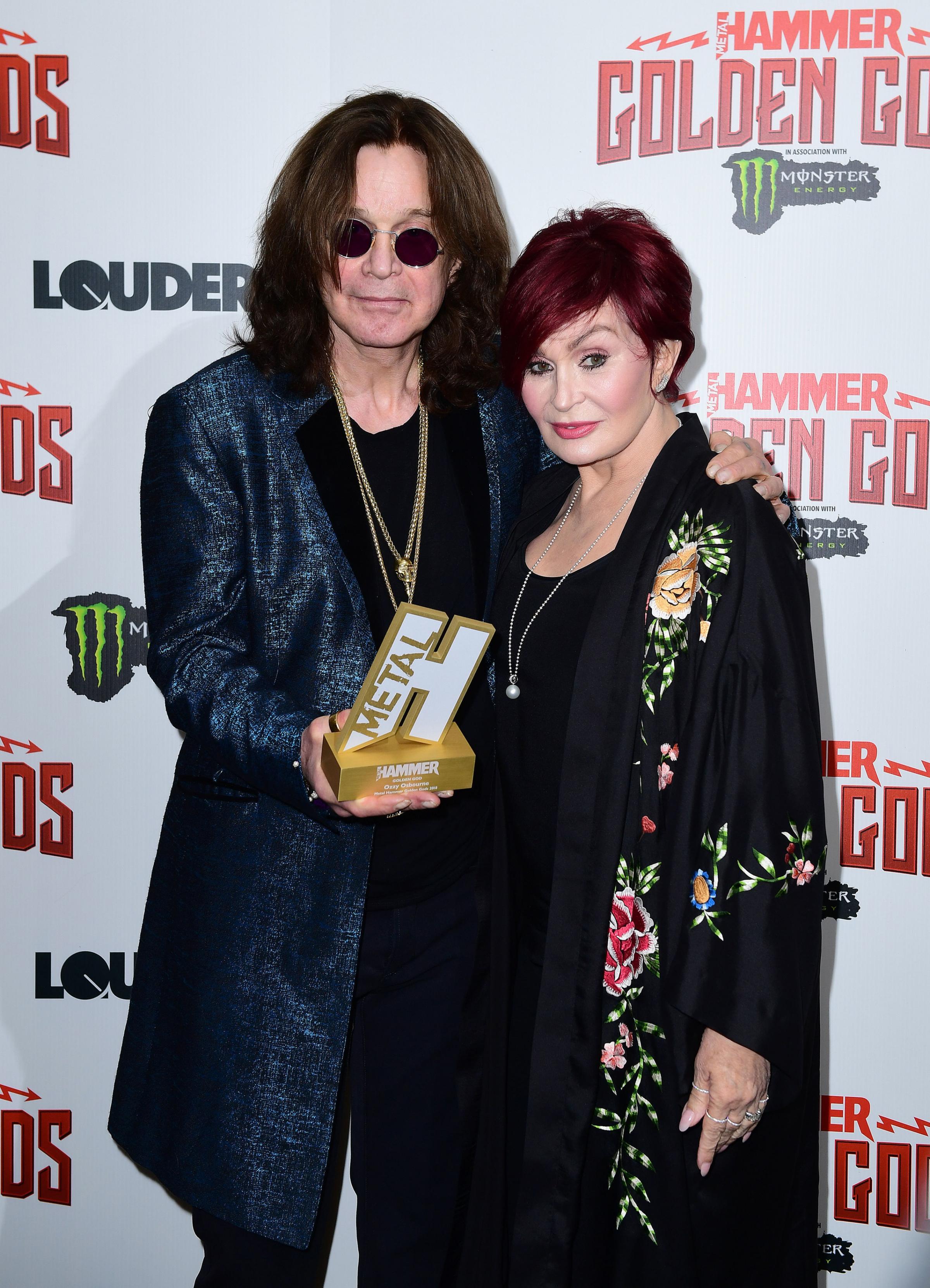 Ozzy Osbourne with his Golden God award and wife Sharon Osbourne in the press room at the Metal Hammer Golden Gods Awards 2018 held at indigo at The O2 in London in June 2018 (Ian West/PA Photos)