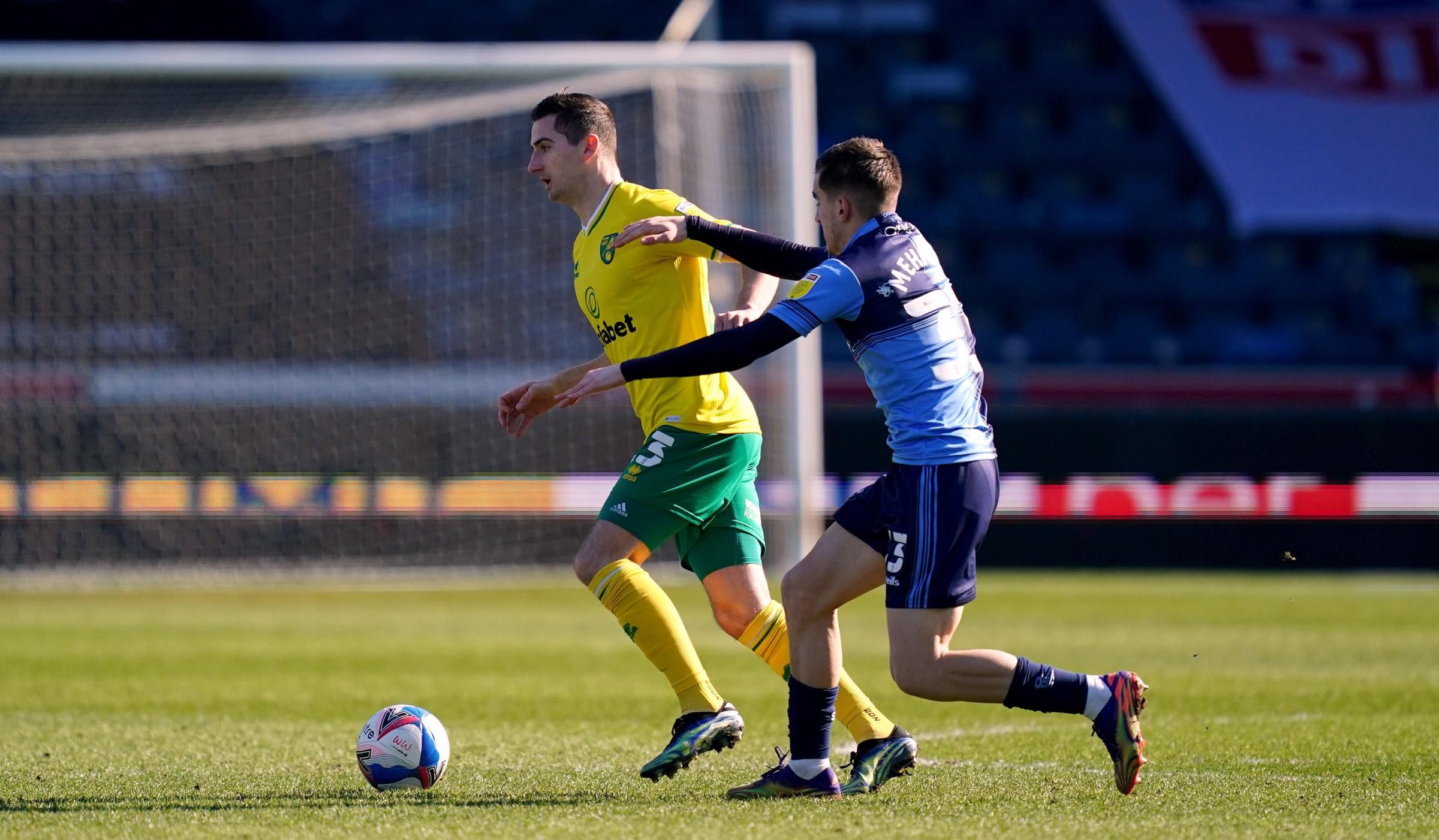 Kenny McClean, who played and scored in the PL for Norwich last season, gets past Anis Mehmeti (PA)