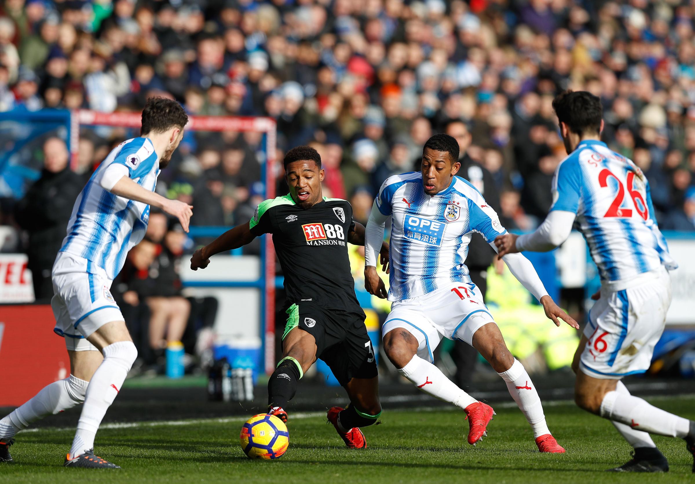 Jordon Ibe (middle left) battles Huddersfield Towns Rajiv van La Parra for the ball during the Premier League match at the John Smiths Stadium on February 11, 2018 (PA)