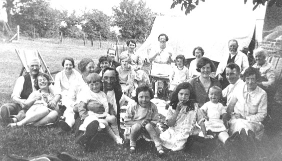 RHW94366 These families are celebrating a birthday party with a picnic in a field at Cadmore End in the summer of 1929. 