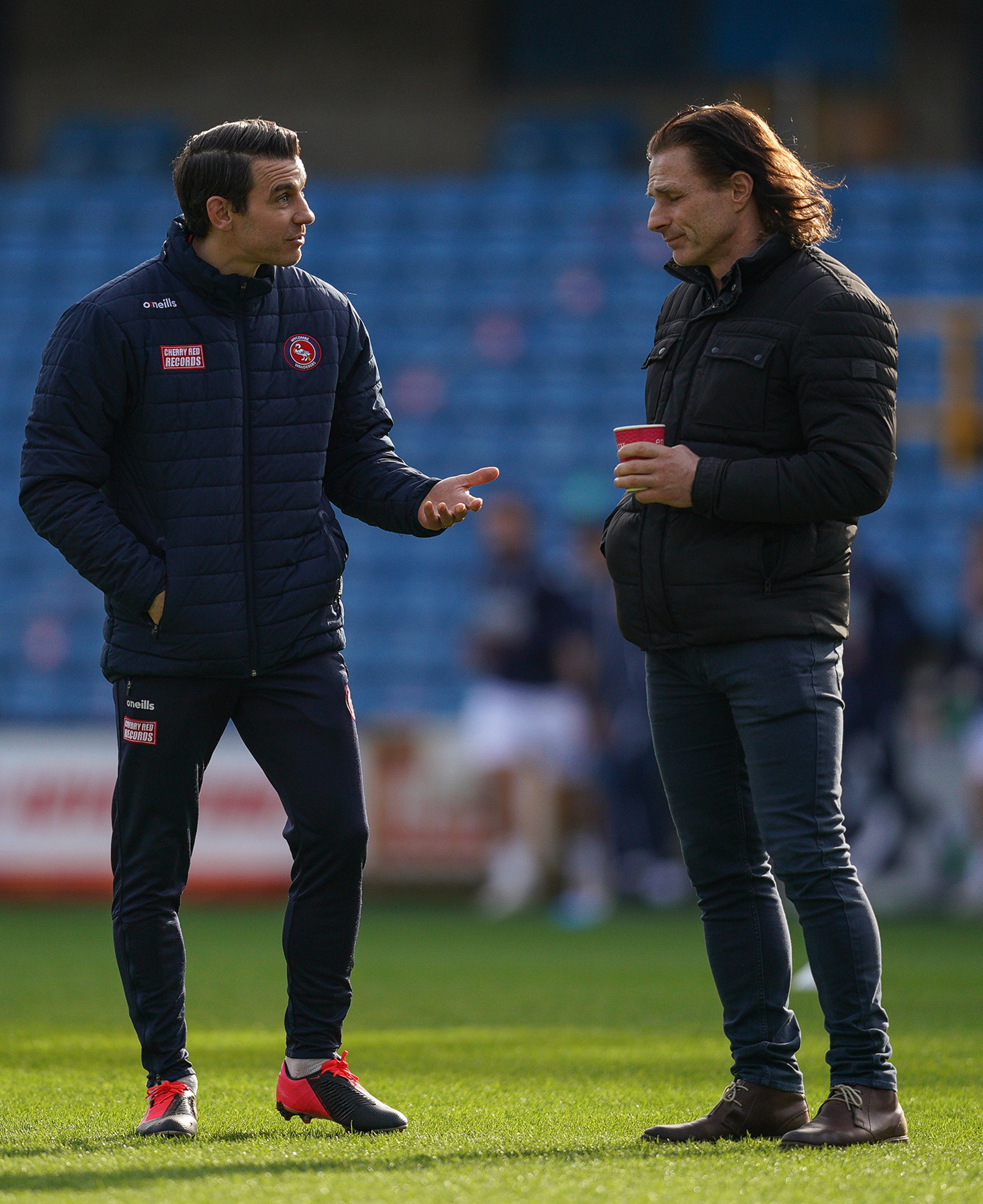 Matt Bloomfield has helped out with the coaching this season, as well as playing for the club - here he is pictured with manager Gareth Ainsworth before the 0-0 draw against Millwall on February 20 (Prime Media)