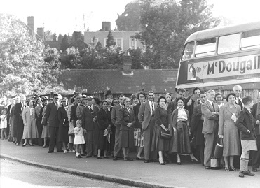 Passengers about to go on Whit-Monday excursions queue outside the London Transport bus garage at the bottom of Marlow Hill, High Wycombe, May 1955