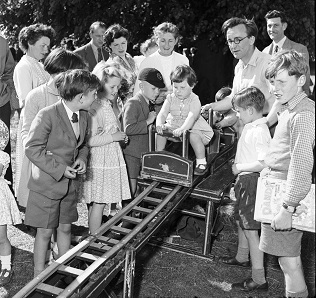 These children are gathered round a “railway slide” at the Whit-Monday Chalfont Fair held in the grounds of Holy Cross Convent in Chalfont St Peter, May 1955