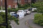 Police forensic team carry out street investigation