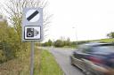 National speed limit sign with a speed camera's symbol underneath, as speed limits of 20mph should be imposed on all roads near schools to reduce the number of child crash deaths, according to a charity.