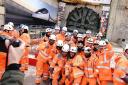 Workers pose for photos after digging machine Florence completed HS2's longest tunnel, a 10-mile journey under the Chiltern Hills