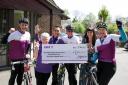 The cyclists presented with a cheque at Catherine Court