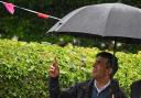 Prime Minister Rishi Sunak under an umbrella during a campaign visit in Market Bosworth, Leicestershire (Aaron Chown/PA)