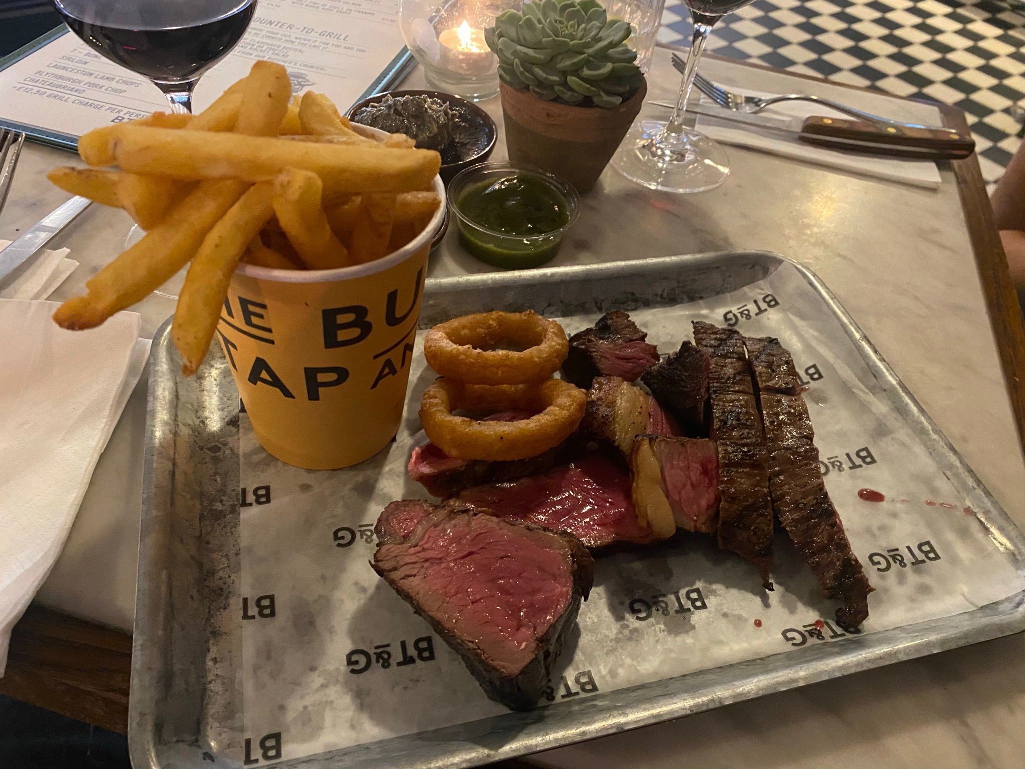 A selection of steaks, chips and onion rings