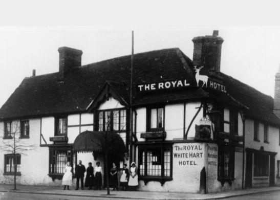 Looking north west. a view of the Royal White Hart Hotel, with the staff (one man and six women) in Beaconsfield in 1920