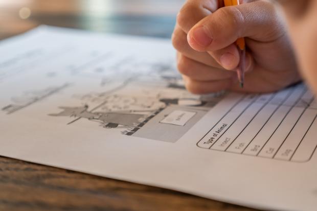Bucks Free Press: A student filling out a worksheet. Credit: Canva