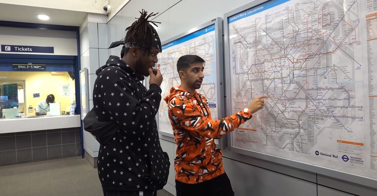 Olatunje and Barn discuss how to get back to London when at a train station