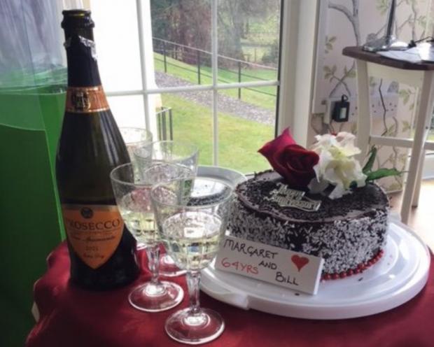 Bucks Free Press: Celebratory bubbly and rose embellished cake with 'Happy Anniversary' decoration
