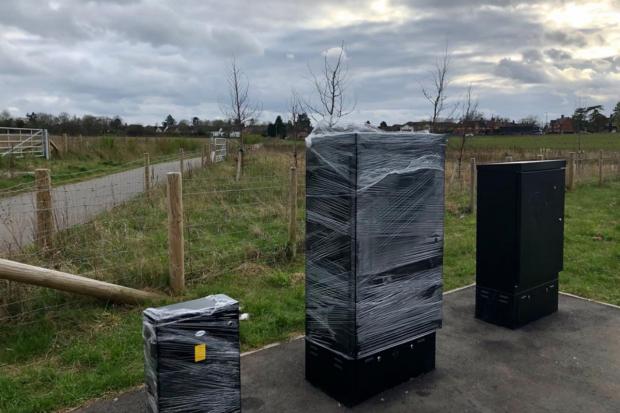 Bucks Free Press: Plastic wrapped electricity and signal boxes on the evening of the road opening. 