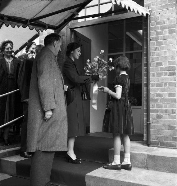 Queen Elizabeth II receiving a bouquet from Crystal Harrison on her visit to Messrs. Harrison and Sons works, Hughenden Avenue, High Wycombe. 10 Nov 1952