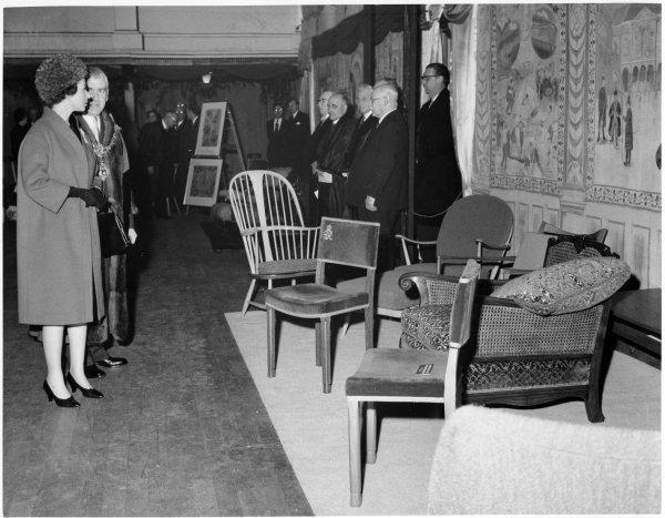 Queen Elizabeth II views locally-made furniture on her visit to the Town Hall, Queen Victoria Road, High Wycombe. April 1962
