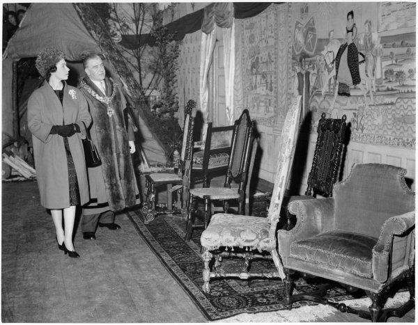 Queen Elizabeth II views a display of furniture and tapestries associated with the town on her visit to the Town Hall, Queen Victoria Road, High Wycombe. April 1962