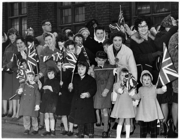 Part of a crowd waving Union Jack flags, probably on the occasion of the visit of Queen Elizabeth II in 1962. Queen Victoria Rod, High Wycombe