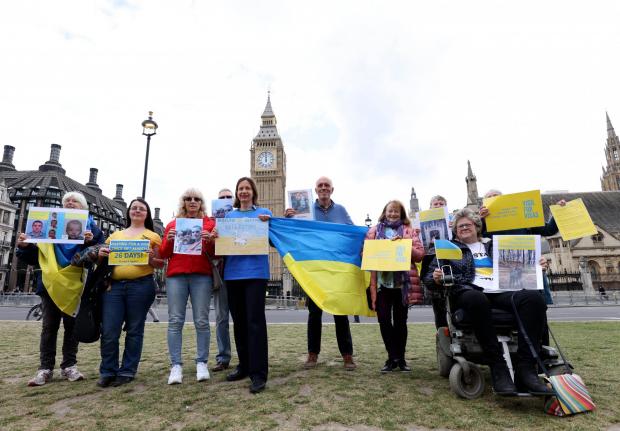 Bucks Free Press: Protesters holding Ukrainian flags and banners outside the Houses of Parliament (PA Media)
