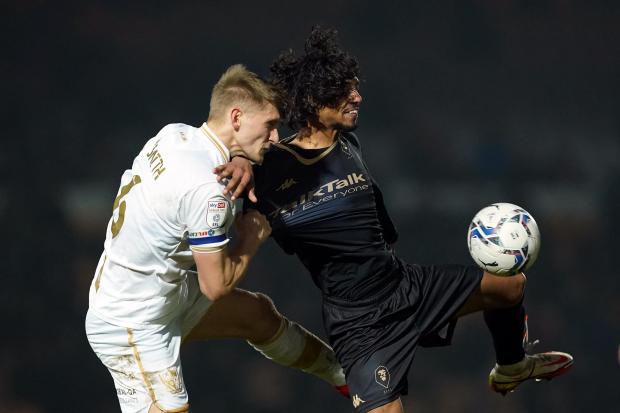 Port Vale's Nathan Smith (left) and Salford City's D'Mani Bughail-Mellor battle for the ball during the Sky Bet League Two match at Vale Park in January 2022 (PA)